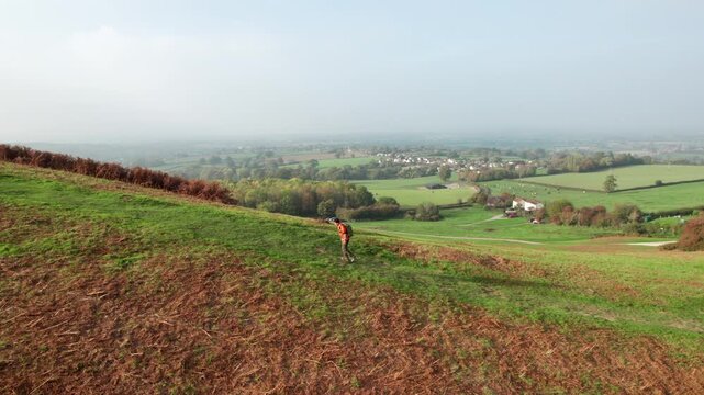 Hiker on the hill in Cotswolds, near Dursley and Uley. Autumn Travel in United Kingdom