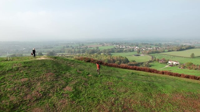 Hiker on the hill in Cotswolds, near Dursley and Uley. Autumn Travel in United Kingdom