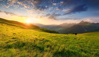 Fototapeta premium Landscape Of Green Field And Meadow In A Hill Countryside With Mountains And Beautiful Sunset