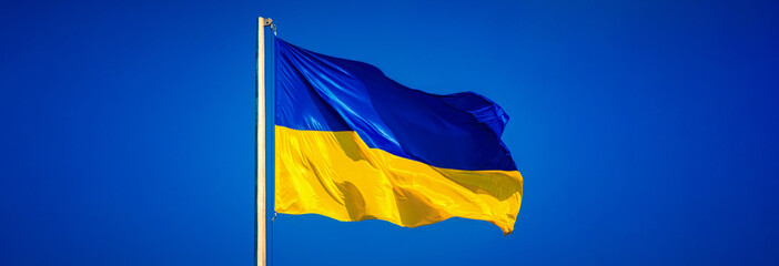 Ukrainian flag against a blue sky. Yellow and blue colors. National symbol of Ukraine. Russian war in Ukraine. Stop war.