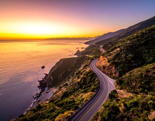 Winding road hugs coastal cliffs under a vibrant, fiery sunrise