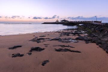 Wooden pier leading to a small island in the sea on the coast of Fuerteventura