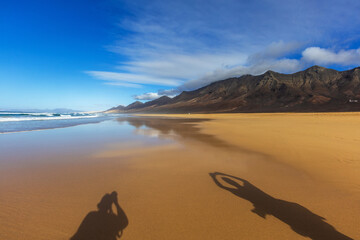 Cofete Beach on Fuerteventura, a beautiful, wild sandy beach with high mountains rising in the...