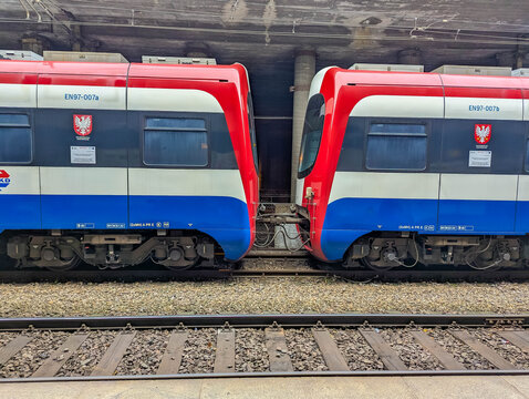 Warsaw, Poland, October 20, 2025. Warszawska Kolej Dojazdowa commuter trains in red white and blue colors parked at station Warsaw Poland. High quality photograph