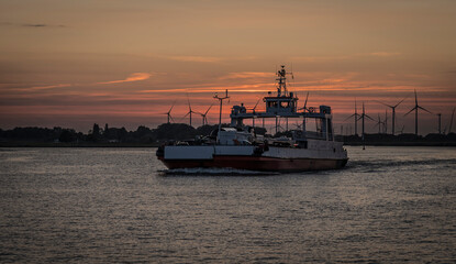Sunset with a ferry on the river Elbe.