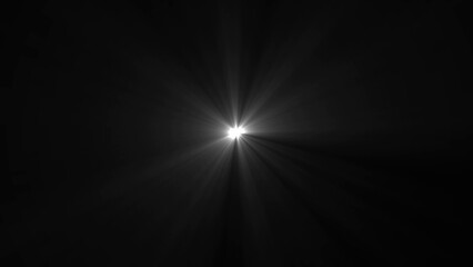 Bright white starburst light flare emanating from center against black background image