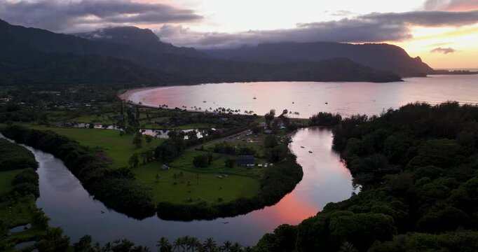 Sunset Aerial Flyover of Hanalei Bay Kauai Hawaii with Reflections on River and Mountains