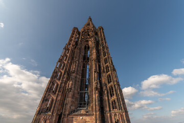 Ancient and impressive view of Strasbourg Cathedral under cloudy sky