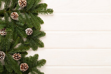 Christmas tree branches on wooden background, top view