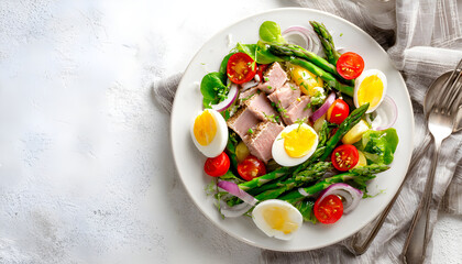 Salad with tuna, tomatoes, asparagus and onion. Salad Nicoise. Flat lay. Top view