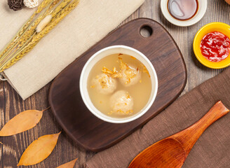 Bowl of Asian meatball soup offers warm, savory comfort, perfect for a quick lunch or cozy dinner. The rustic wooden table adds to the inviting and delicious experience.