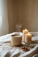 Minimal oak nightstand with candle trio and ceramic cup steam