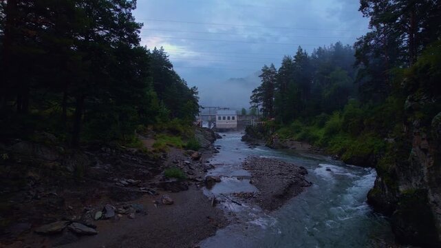 Chemal hydroelectric power plant with fog. Altai Siberia Russia, aerial top view.
