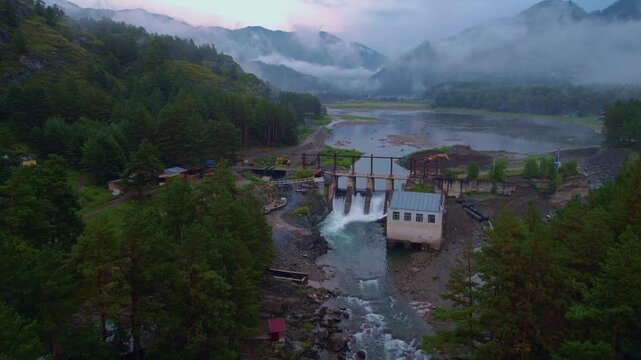 Chemal hydroelectric power plant with fog. Altai Siberia Russia, aerial top view.