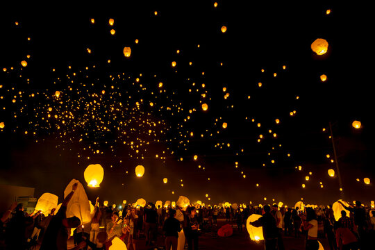 Sky lanterns rise over the desert night sky