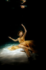 An Ethereal Underwater Dance Captured in a Beautiful and Flowing Golden Dress, Graceful and Sublime