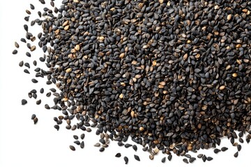 A large pile of dark-colored sesame seeds, some scattered, on a white background, showcasing their texture and color variation