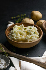 Mushed potatoes top view with raw potatoes and spices