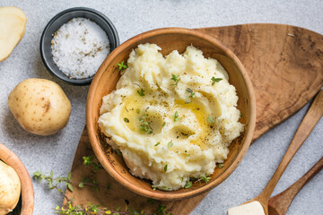 Mushed potatoes top view with raw potatoes and spices
