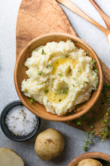 Mushed potatoes top view with raw potatoes and spices