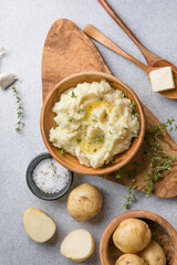 Mushed potatoes top view with raw potatoes and spices