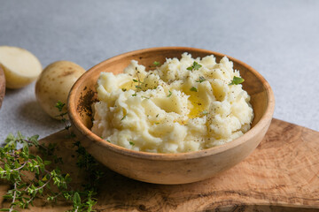 Mushed potatoes top view with raw potatoes and spices