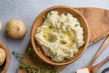 Mushed potatoes top view with raw potatoes and spices
