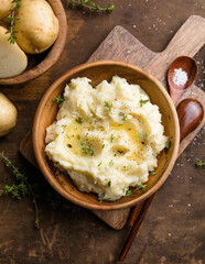 Mushed potatoes top view with raw potatoes and spices