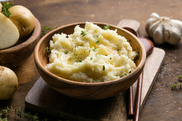 Mushed potatoes top view with raw potatoes and spices