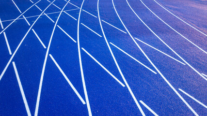 Aerial image of a new blue and yellow eight, 8, lane running track with white lane lines and other markings.	