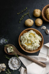 Mushed potatoes top view with raw potatoes and spices