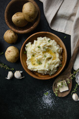 Mushed potatoes top view with raw potatoes and spices
