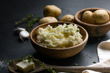 Mushed potatoes top view with raw potatoes and spices