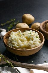 Mushed potatoes top view with raw potatoes and spices