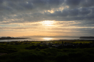 Sunset view of an ocean and suburban area from a high ground