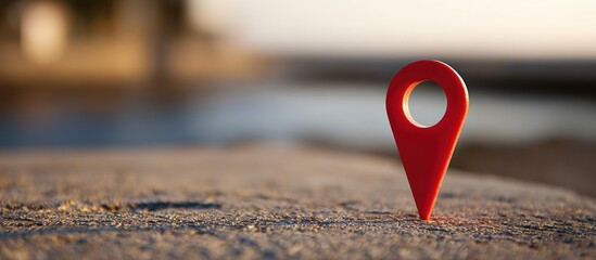 A close-up shot of a red location marker on a textured surface with blurred background.