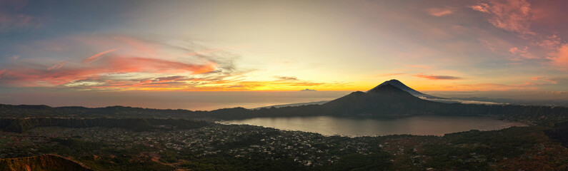 golden sunrise scene, morning glow over lake and volcano, sunrise illuminating lake with volcano Kintamani Bali