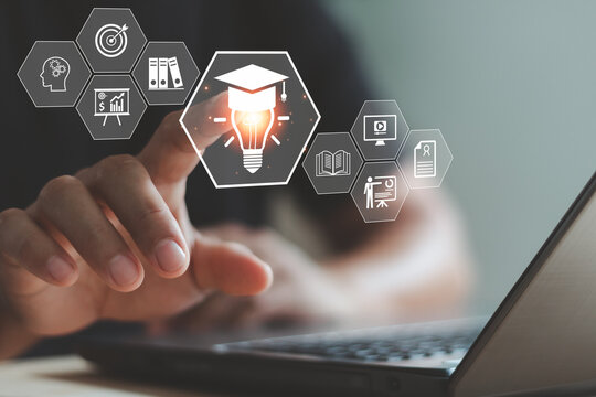 Online education and e-learning concept with hand using laptop and virtual icons of graduation, knowledge and innovation, representing digital learning, training and self development. - Powered by Adobe