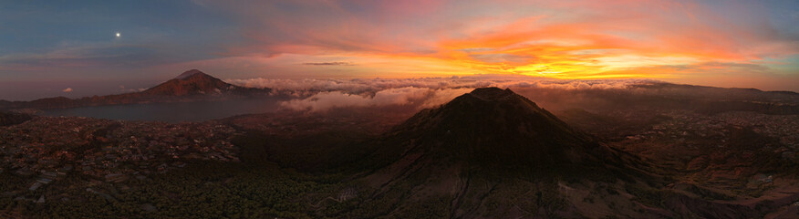 Fototapeta premium dramatic morning scene above erupting volcano with colorful clouds and awakening wilderness Kintamani Batur Abang Angung Bali