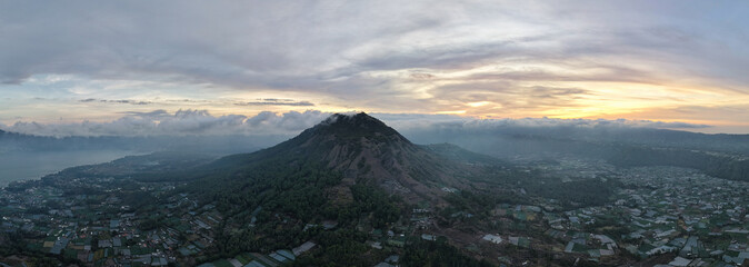 misty morning landscape, dawn over foggy mountain town, quiet early morning with misty Batur mountain Kintamani Bali