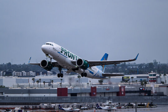 Sky Harbor Airport 10-11-2025 Phoenix AZ USAFrontier Airlines Airbus A320Neo N372FR departure from 7L at a rain soaked  Phoenix Sky Harbor Intl. Airport