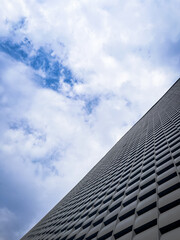 Abstract Modern Architecture Facade with Cloudy Sky Perspective