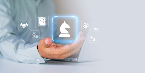 Digital business strategy and innovation planning concept showing chess knight icon with financial growth, teamwork and process management symbols, corporate decision-making, strategic leadership © LAONG