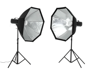 Two octagonal studio lights with silver interiors on black stands, black background