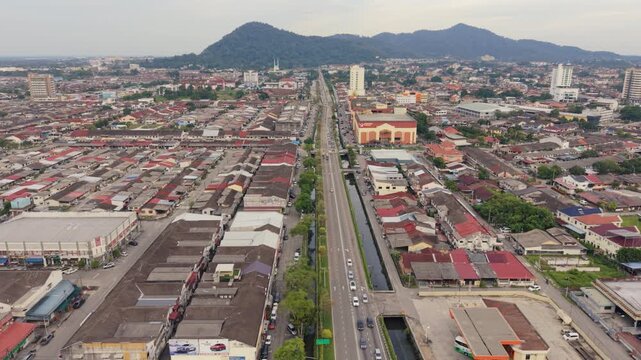 Batu Pahat Town Evening Aerial View with Scenic Mountain Backdrop, Malaysia

