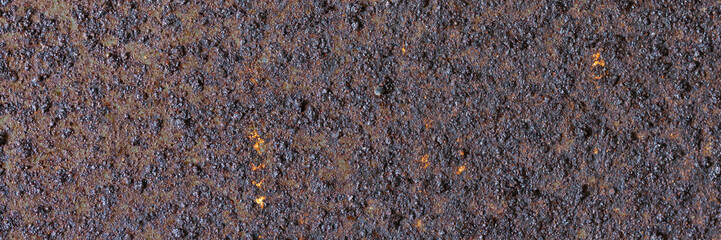 Texture of rusty metal. Rough metal surface with rust. Corroded and oxidized old iron. Rusted and aged metal sheet. Wide panoramic texture for background and design in grunge style.