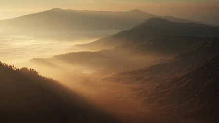 Stunning sunrise view over Mount Bromo, East Java, Indonesia, volcanic caldera with mist and golden hour light.