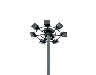 A tall, metal pole topped with a circular array of bright lights against a black sky
