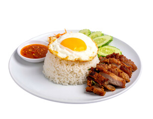 A plate of rice with fried egg, grilled pork, cucumber, and spicy sauce