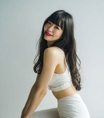 Fototapeta premium Portrait of a Japanese woman with soft features, exuding elegance and refined beauty. The classic pose, along with subtle lighting, creates a sophisticated, high fashion look.